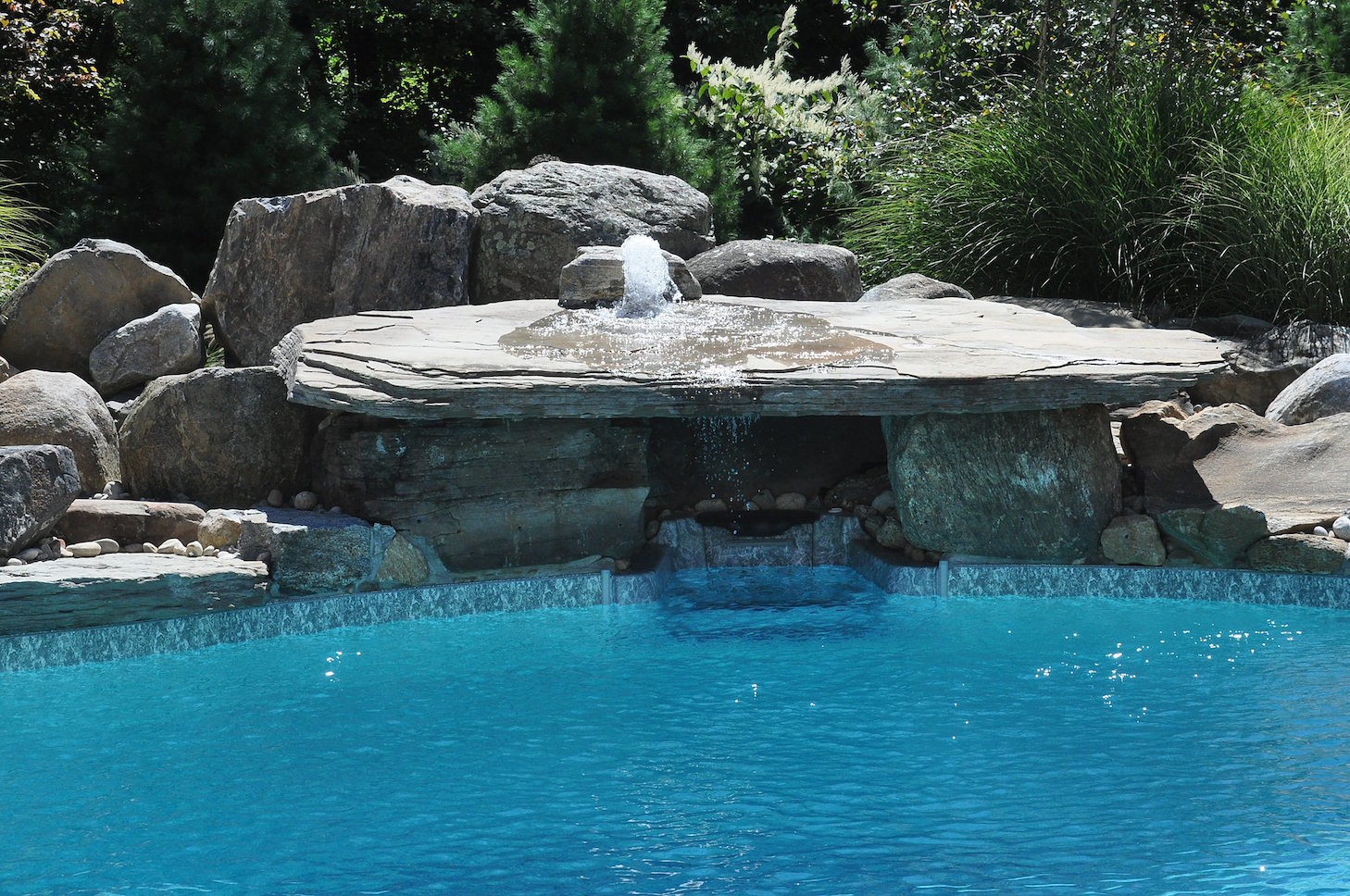 Residential landscape with water feature providing texture and atmosphere